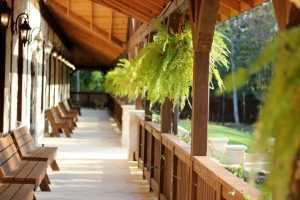 Home Gezellige overkapping of veranda in tuin met loungezetel en planten voor optimaal vakantiegevoel